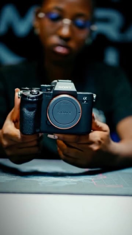 A Camera Hub staffer holding a Sony mirrorless body